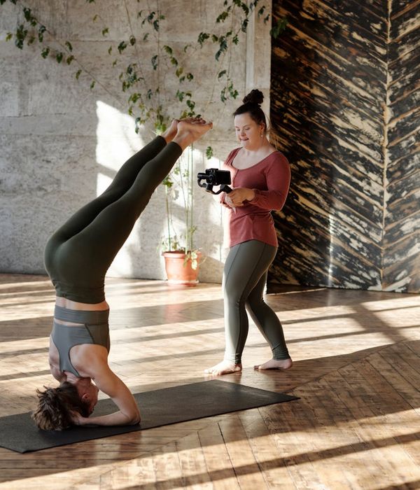 Person practicing gentle yoga movements in a dark room